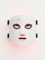 Facial mask with 'Aeterna' branding on a light pink background