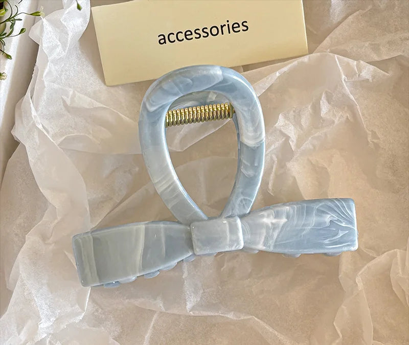 Crafted with a sleek Ocean Blue Clip finish and a sturdy gold spring, this 8cm claw clip holds your hair securely without tugging or damage. Whether you’re heading to class, a brunch date, or just lounging at home, it’s your go-to accessory for effortless beauty.