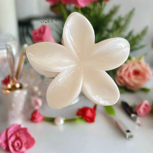 Crafted in a stunning five-petal design with shimmering, Pearl-inspired hues, this clip catches the light beautifully from every angle. Perfect for securing hair effortlessly while elevating your look—whether for casual days, beach vibes, or special occasions.